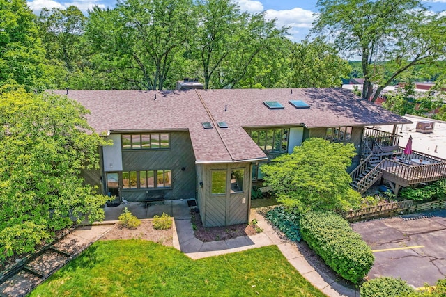 2109 W 5th Ave Unit C, Grandview Heights, OH 43212 - view of front facade with a shingled roof, a front lawn, uncovered parking, stairway, and a chimney