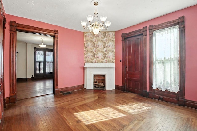 366 Hudson Ave, Newark, OH 43055 - unfurnished living room with a chandelier, a fireplace, and wood-type flooring