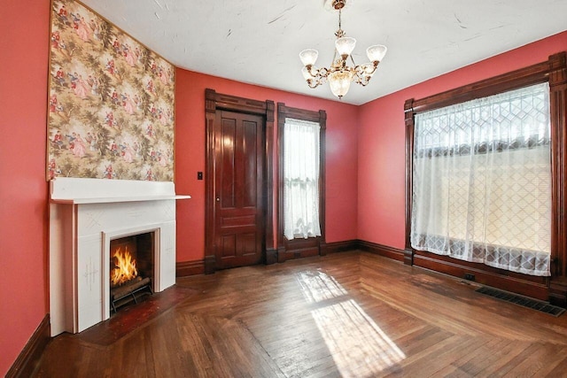 366 Hudson Ave, Newark, OH 43055 - unfurnished living room featuring a chandelier and a warm lit fireplace