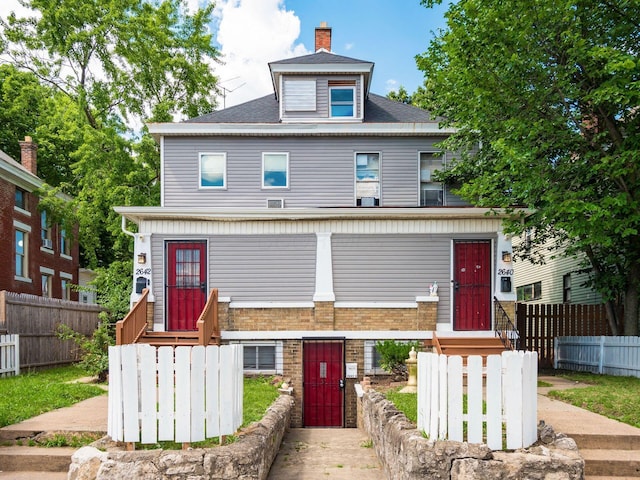 2640-2642 W Broad St, Columbus, OH 43204 - traditional style home with a fenced front yard, a gate, and a chimney