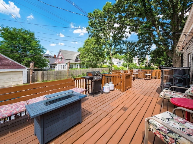 2640-2642 W Broad St, Columbus, OH 43204 - wooden deck featuring area for grilling, a fire pit, and outdoor dining space