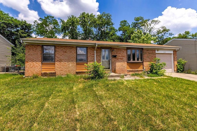 3162 New Year Dr, Cincinnati, OH 45251 - view of front of home featuring an attached garage, brick siding, a front lawn, and driveway
