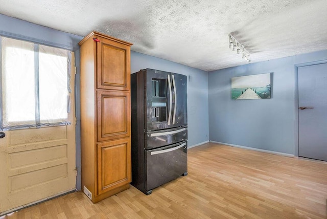 3162 New Year Dr, Cincinnati, OH 45251 - kitchen with refrigerator with ice dispenser, a textured ceiling, light wood-style flooring, brown cabinets, and track lighting