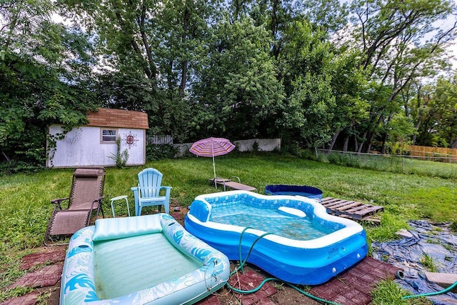 3162 New Year Dr, Cincinnati, OH 45251 - view of swimming pool featuring a fenced backyard and a storage shed