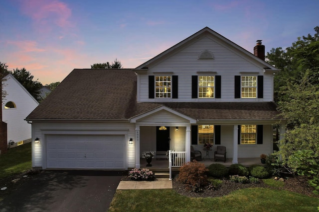 6041 Tetlin Field Dr, New Albany, OH 43054 - traditional-style house featuring a porch, asphalt driveway, a chimney, a garage, and roof with shingles