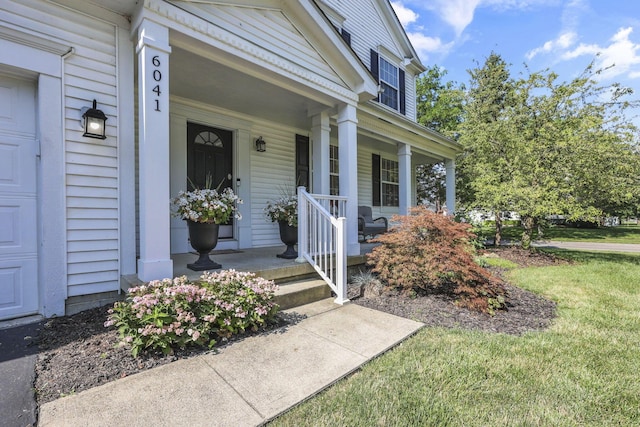 6041 Tetlin Field Dr, New Albany, OH 43054 - view of exterior entry with covered porch and a lawn