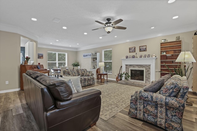 6041 Tetlin Field Dr, New Albany, OH 43054 - living area with ceiling fan, wood finished floors, ornamental molding, recessed lighting, and a brick fireplace