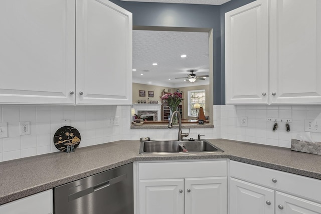 6041 Tetlin Field Dr, New Albany, OH 43054 - kitchen featuring stainless steel dishwasher, ceiling fan, a textured ceiling, white cabinetry, and tasteful backsplash