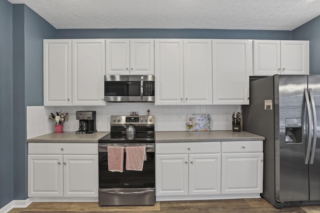 6041 Tetlin Field Dr, New Albany, OH 43054 - kitchen with appliances with stainless steel finishes, wood finished floors, a textured ceiling, decorative backsplash, and white cabinets