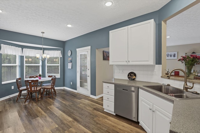 6041 Tetlin Field Dr, New Albany, OH 43054 - kitchen with stainless steel dishwasher, a textured ceiling, a chandelier, white cabinetry, and backsplash
