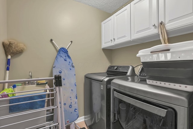 6041 Tetlin Field Dr, New Albany, OH 43054 - laundry area featuring cabinet space, washer and dryer, and a textured ceiling