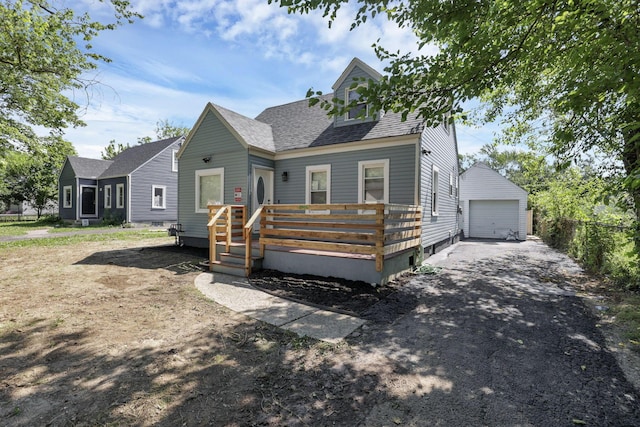 1808 Brentnell Ave, Columbus, OH 43219 - view of front of property with roof with shingles, an outbuilding, a detached garage, a deck, and driveway