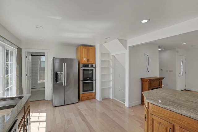 1808 Brentnell Ave, Columbus, OH 43219 - kitchen featuring appliances with stainless steel finishes, light wood-style flooring, light stone countertops, recessed lighting, and brown cabinets