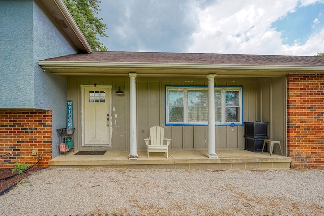 3910 Summit View Rd, Dublin, OH 43016 - doorway to property with covered porch, board and batten siding, brick siding, and a shingled roof