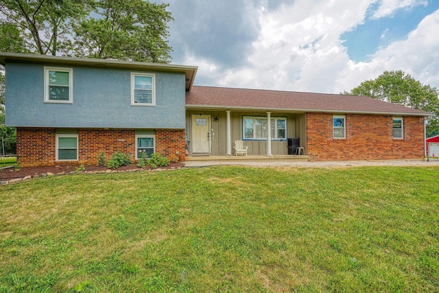 3910 Summit View Rd, Dublin, OH 43016 - tri-level home featuring a front yard, covered porch, and brick siding