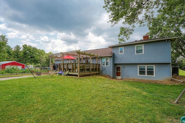 3910 Summit View Rd, Dublin, OH 43016 - back of property featuring a wooden deck, a chimney, stucco siding, a lawn, and a pergola