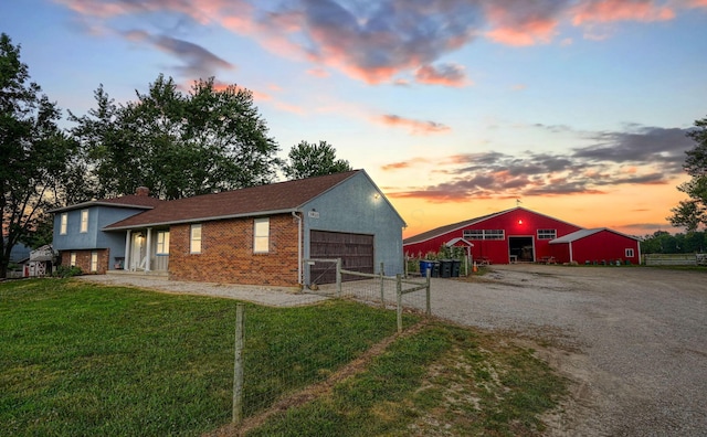 3910 Summit View Rd, Dublin, OH 43016 - outdoor structure at dusk featuring gravel driveway, a garage, and an outbuilding
