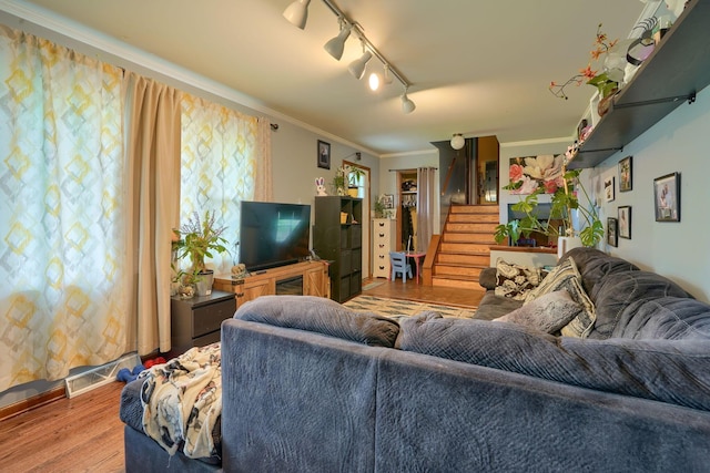 3910 Summit View Rd, Dublin, OH 43016 - living area featuring wood finished floors, stairway, crown molding, and rail lighting