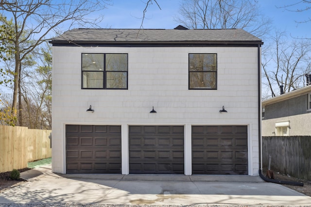 86 W N Broadway, Columbus, OH 43214 - view of front of house featuring a garage, a shingled roof, and driveway