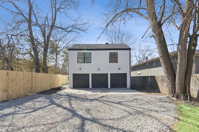 86 W N Broadway, Columbus, OH 43214 - rear view of property with gravel driveway and a garage