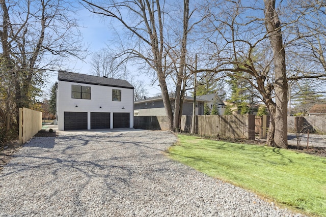 86 W N Broadway, Columbus, OH 43214 - view of front facade featuring gravel driveway and an attached garage
