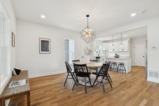 86 W N Broadway, Columbus, OH 43214 - dining space featuring light wood finished floors, recessed lighting, and a chandelier