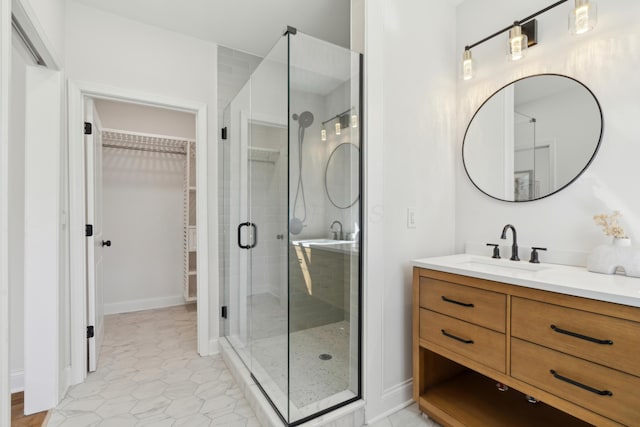 86 W N Broadway, Columbus, OH 43214 - bathroom featuring vanity, a shower stall, a walk in closet, and tile patterned floors