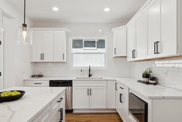 86 W N Broadway, Columbus, OH 43214 - kitchen with stainless steel dishwasher, black microwave, white cabinetry, recessed lighting, and pendant lighting
