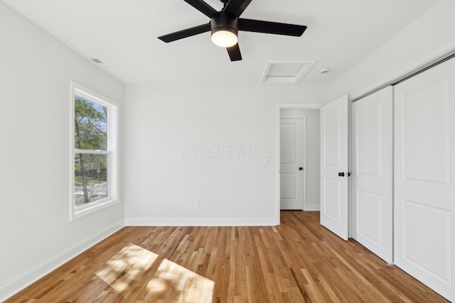 86 W N Broadway, Columbus, OH 43214 - unfurnished bedroom with attic access, light wood finished floors, a closet, and a ceiling fan