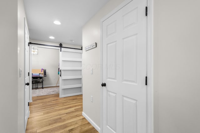 6750 Constitution Way, Powell, OH 43065 - corridor with a barn door, light wood finished floors, and recessed lighting