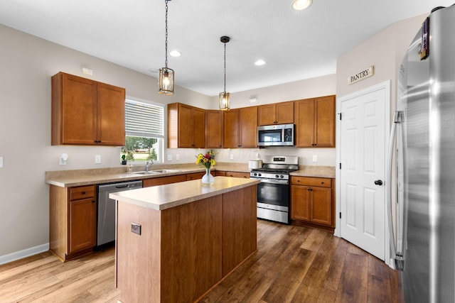 6750 Constitution Way, Powell, OH 43065 - kitchen featuring stainless steel appliances, light countertops, wood finished floors, recessed lighting, and brown cabinetry