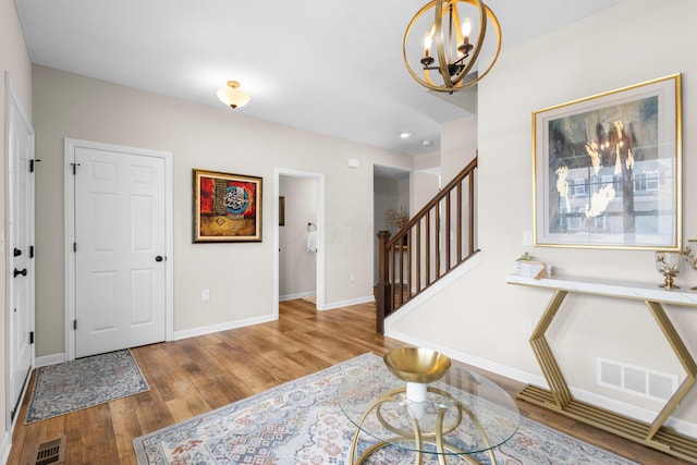 6750 Constitution Way, Powell, OH 43065 - foyer entrance featuring wood finished floors, a chandelier, and stairs