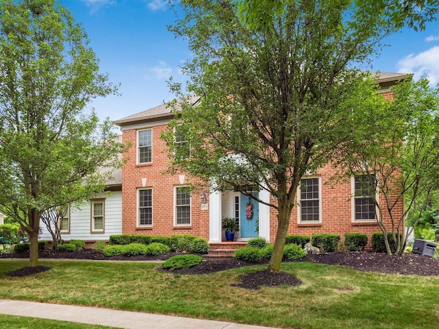 6676 Ballantrae Pl, Dublin, OH 43016 - view of front of home with a front lawn, brick siding, and a shingled roof