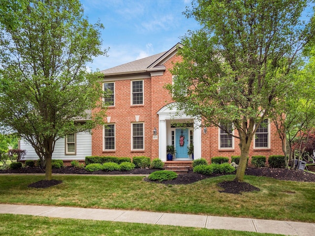6676 Ballantrae Pl, Dublin, OH 43016 - colonial house with a front lawn and brick siding