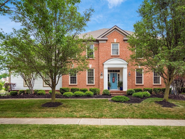 6676 Ballantrae Pl, Dublin, OH 43016 - view of front of home featuring a front yard and brick siding