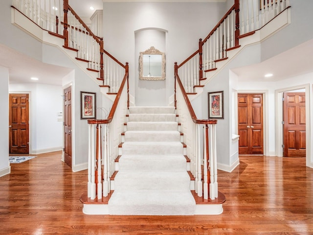6676 Ballantrae Pl, Dublin, OH 43016 - stairway featuring wood finished floors, a high ceiling, and recessed lighting