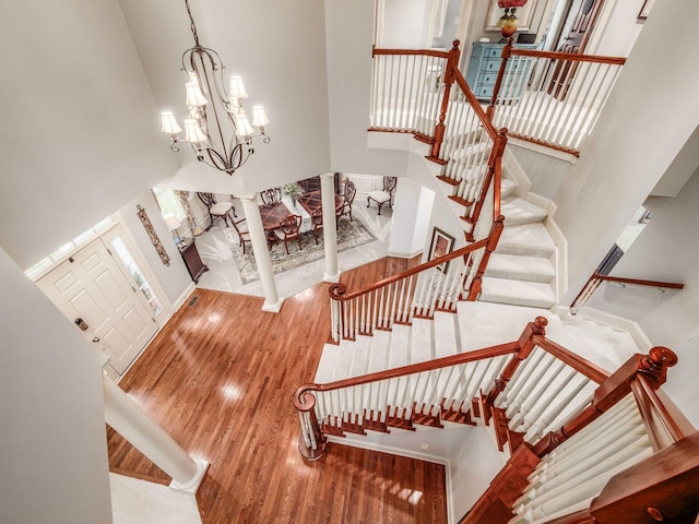 6676 Ballantrae Pl, Dublin, OH 43016 - foyer featuring a high ceiling, wood finished floors, stairs, and a chandelier