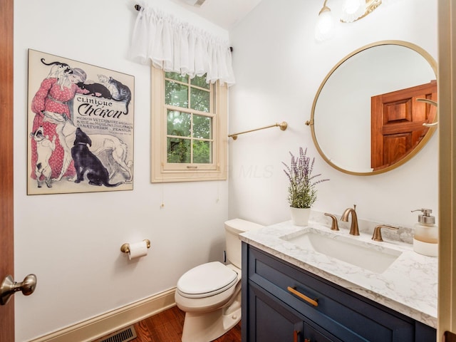 6676 Ballantrae Pl, Dublin, OH 43016 - half bathroom featuring vanity and wood finished floors