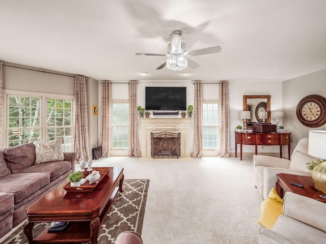 6676 Ballantrae Pl, Dublin, OH 43016 - carpeted living area featuring a ceiling fan, a fireplace with flush hearth, and plenty of natural light