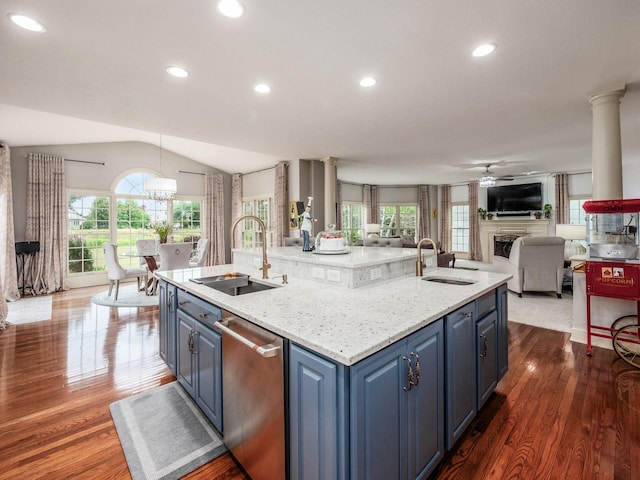 6676 Ballantrae Pl, Dublin, OH 43016 - kitchen featuring stainless steel dishwasher, open floor plan, a center island with sink, a fireplace, and ceiling fan