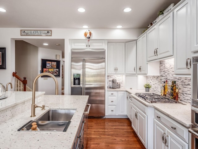 6676 Ballantrae Pl, Dublin, OH 43016 - kitchen featuring stainless steel appliances, white cabinets, tasteful backsplash, dark wood-type flooring, and recessed lighting