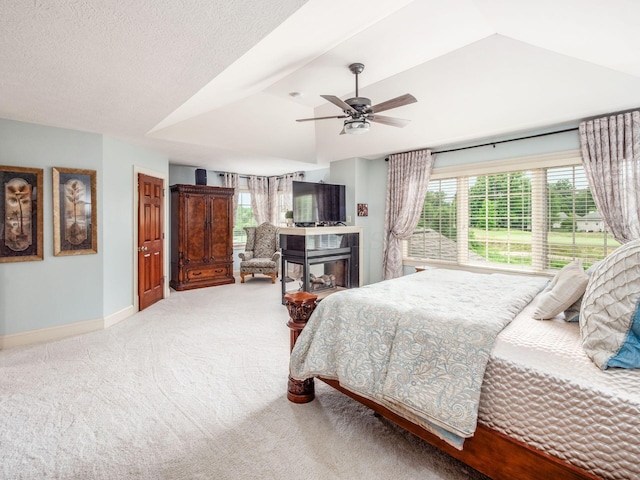 6676 Ballantrae Pl, Dublin, OH 43016 - bedroom with carpet flooring, a ceiling fan, vaulted ceiling, and a multi sided fireplace