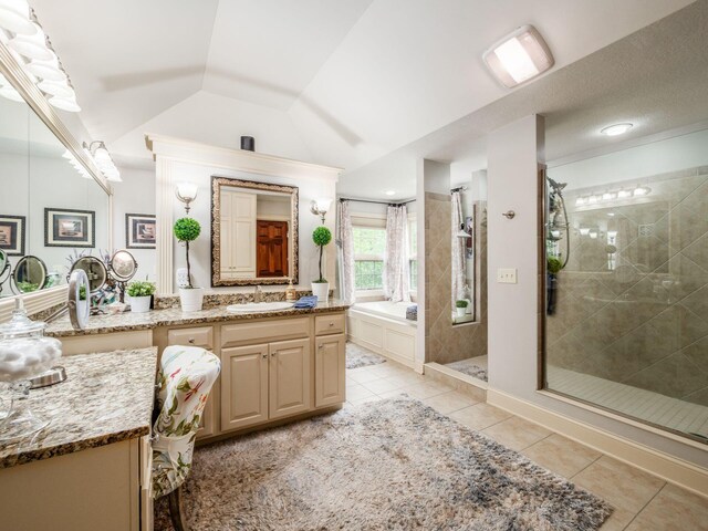 6676 Ballantrae Pl, Dublin, OH 43016 - bathroom featuring a stall shower, vanity, tile patterned flooring, lofted ceiling, and a garden tub