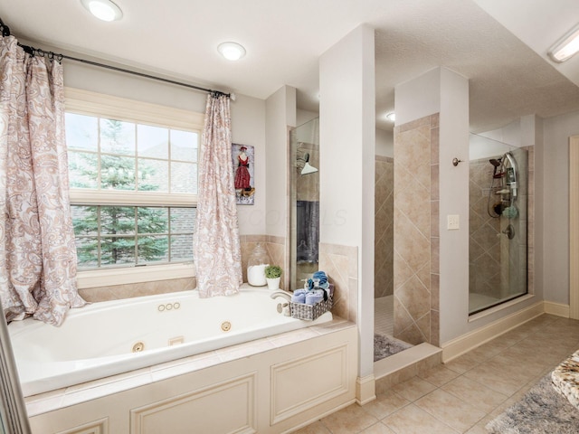 6676 Ballantrae Pl, Dublin, OH 43016 - bathroom with a stall shower, a jetted tub, and tile patterned floors