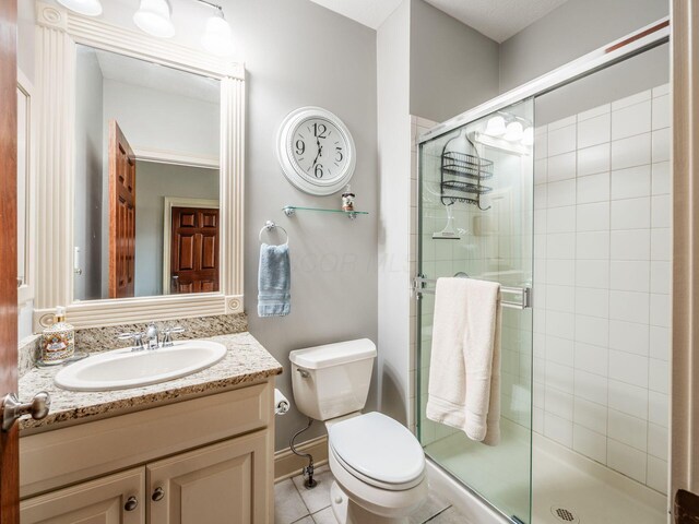 6676 Ballantrae Pl, Dublin, OH 43016 - bathroom featuring a stall shower, vanity, and tile patterned flooring