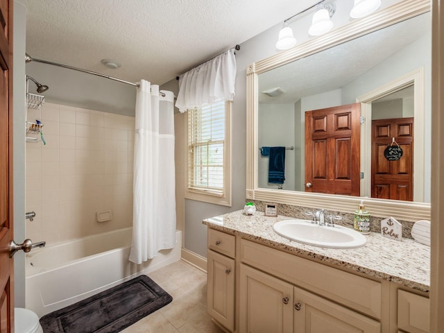 6676 Ballantrae Pl, Dublin, OH 43016 - full bathroom featuring vanity, shower / bath combo, tile patterned floors, and a textured ceiling