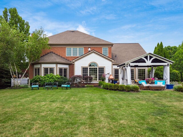 6676 Ballantrae Pl, Dublin, OH 43016 - rear view of house featuring an outdoor hangout area, a yard, roof with shingles, and brick siding
