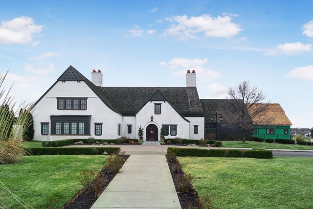 6676 Ballantrae Pl, Dublin, OH 43016 - french country style house featuring a chimney and a front yard