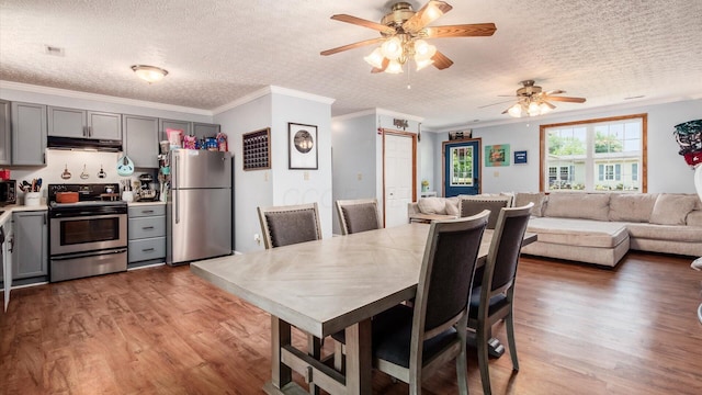 13376 Maple Rd NE, Thornville, OH 43076 - dining space featuring a textured ceiling, wood finished floors, a ceiling fan, and ornamental molding