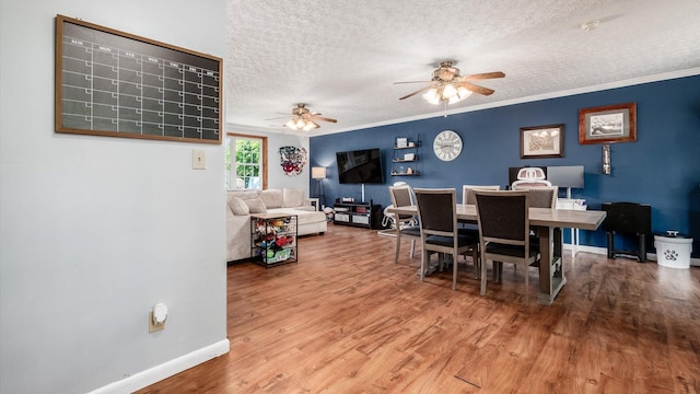 13376 Maple Rd NE, Thornville, OH 43076 - dining area with a textured ceiling, wood finished floors, ceiling fan, and ornamental molding